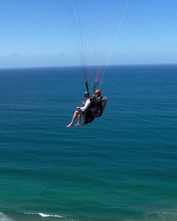 Scotty paragliding over the Pacific Ocean